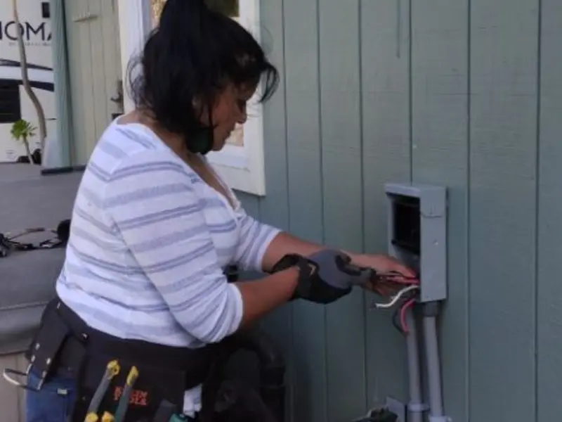 Licensed electrician wiring an exterior subpanel in Kennewick